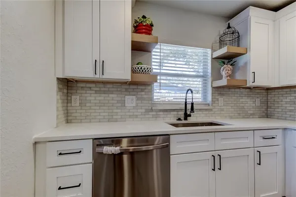 a kitchen with a sink and cabinets