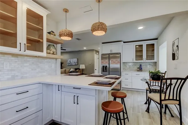 a kitchen with cabinets appliances and furniture