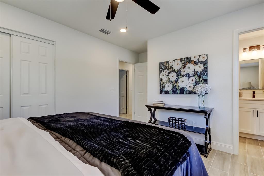 509 11th Street Northwest Largo, FL 33770 - Photo 19 of 36 a bedroom with bed and painting on the wall