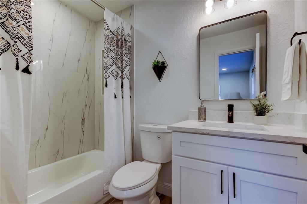 509 11th Street Northwest Largo, FL 33770 - Photo 22 of 36 a bathroom with a sink a toilet and shower