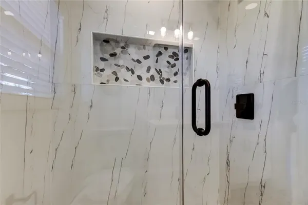a bathroom with a shower and a sink