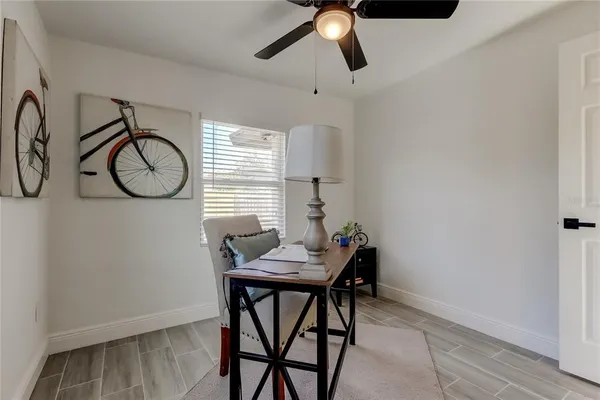 a view of a workspace with furniture and a window