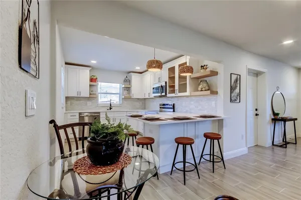 a view of kitchen with cabinets table and chairs