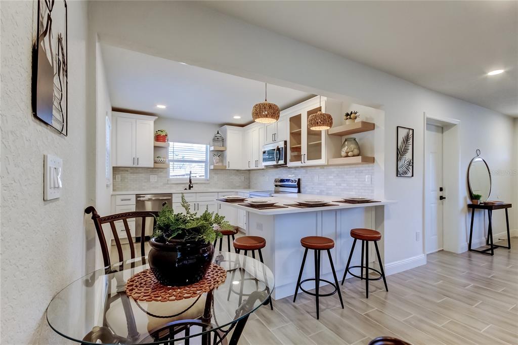 509 11th Street Northwest Largo, FL 33770 - Photo 9 of 36 a view of kitchen with cabinets table and chairs
