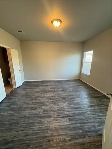 a view of room with window and wooden floor