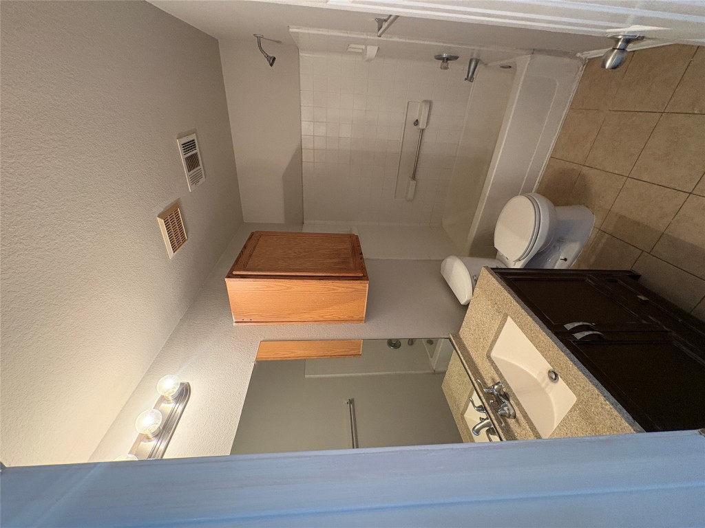11510 Liberty Street Manor, TX 78653 - Photo 25 of 26 a bathroom with a sink a toilet and shower