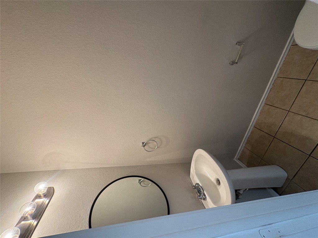 11510 Liberty Street Manor, TX 78653 - Photo 6 of 26 a bathroom with a sink and a mirror