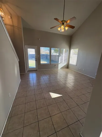 a view of a livingroom with a ceiling fan and window