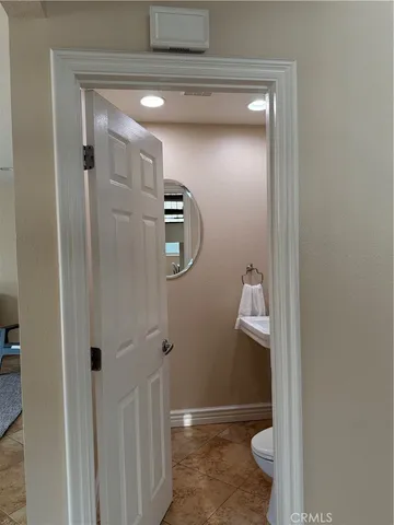 a bathroom with a granite countertop shower a toilet and a sink