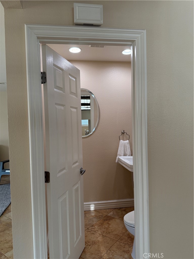 1030 Damascus Circle, Unit 1 Costa Mesa, CA 92626 - Photo 17 of 20 a bathroom with a granite countertop shower a toilet and a sink