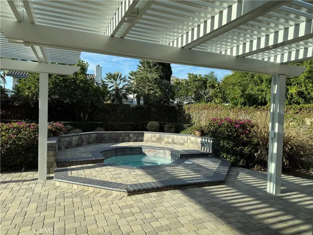 a view of a patio with table and chairs potted plants with wooden floor and floor to ceiling window