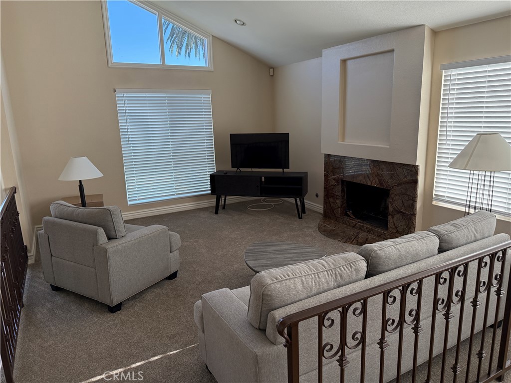 1030 Damascus Circle, Unit 1 Costa Mesa, CA 92626 - Photo 8 of 20 a living room with furniture a fireplace and a flat screen tv