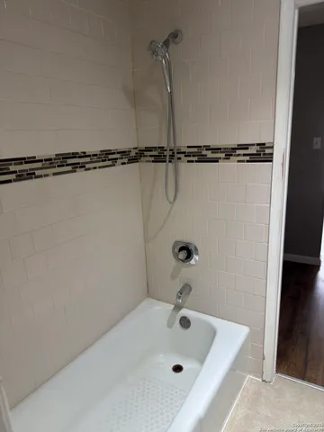 a bathroom with a tub and a shower