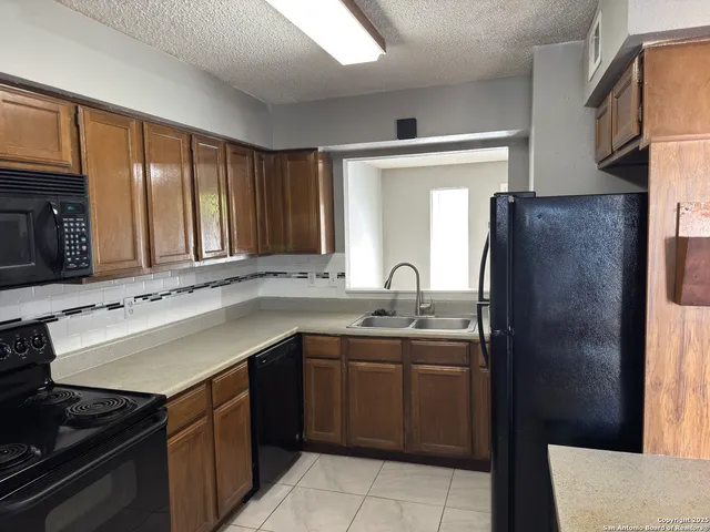 a kitchen with a sink and a refrigerator