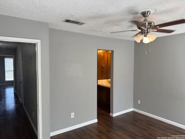 wooden floor in an empty room with a mirror