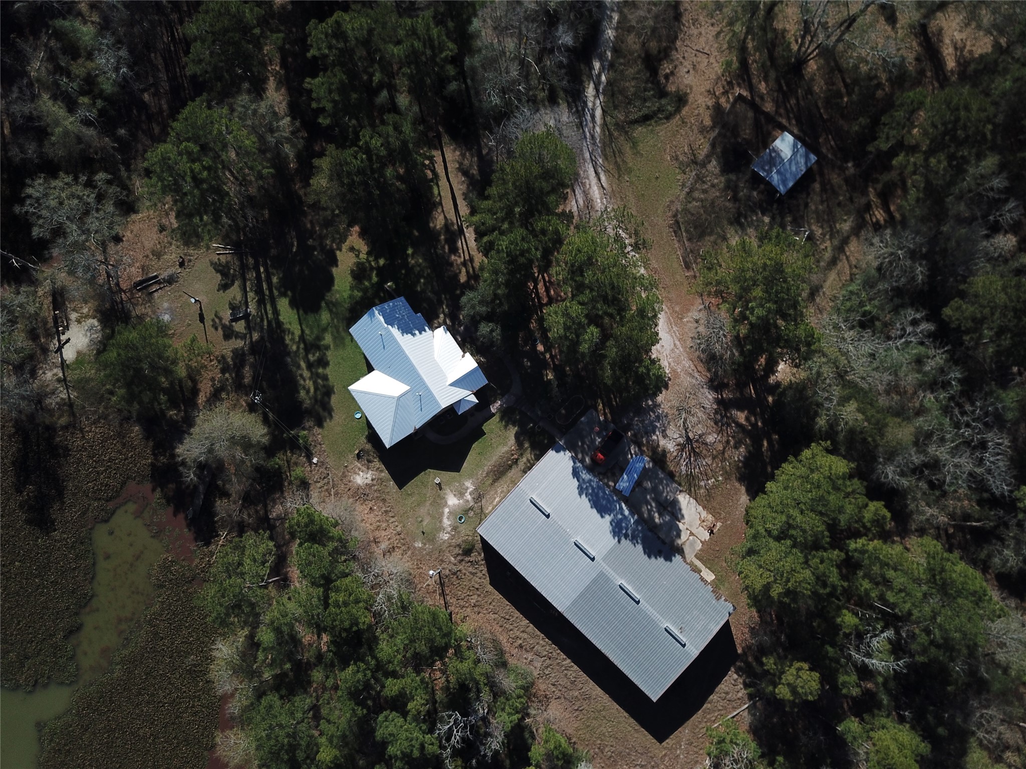 55 Lake Road Huntsville, TX 77320 - Photo 2 of 50 = 3,000 sq ft house and 5000 sq ft Mueller Building on 53 acres! HELLO!!