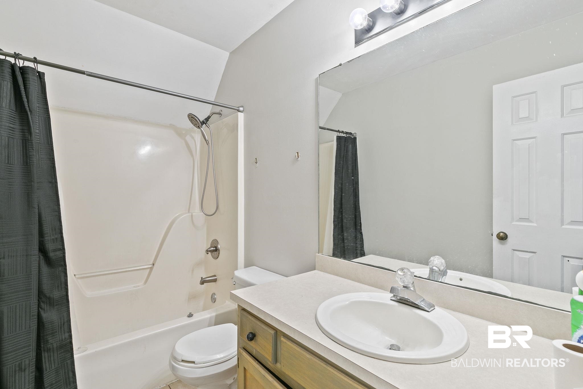 474 Ridgewood Drive Daphne, AL 36526 - Photo 39 of 57 Full bathroom featuring vanity, vaulted ceiling, shower / bath combination with curtain, and toilet