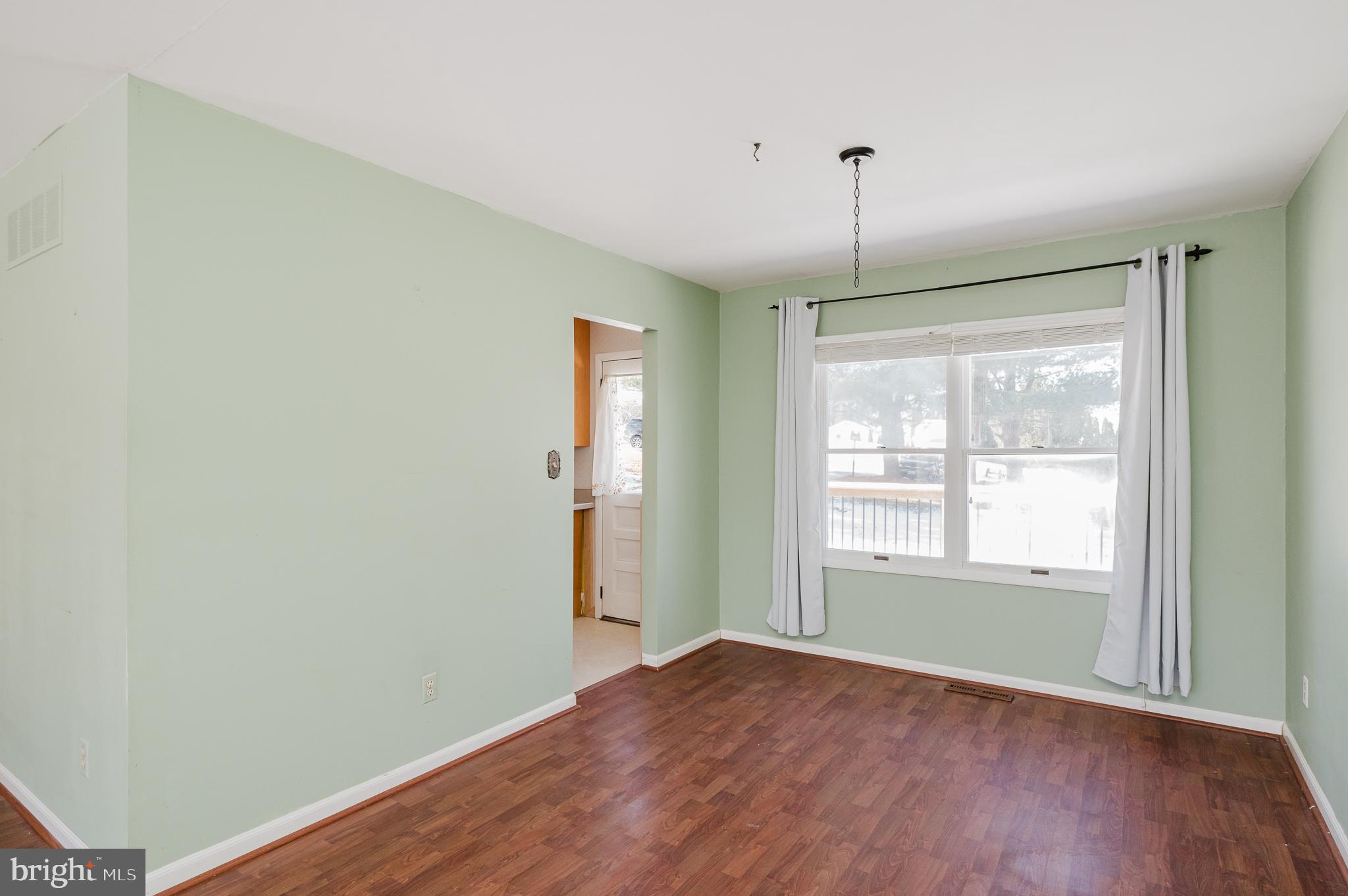 2804 Rocks Road Jarrettsville, MD 21084 - Photo 17 of 46 a view of an empty room with wooden floor and a window