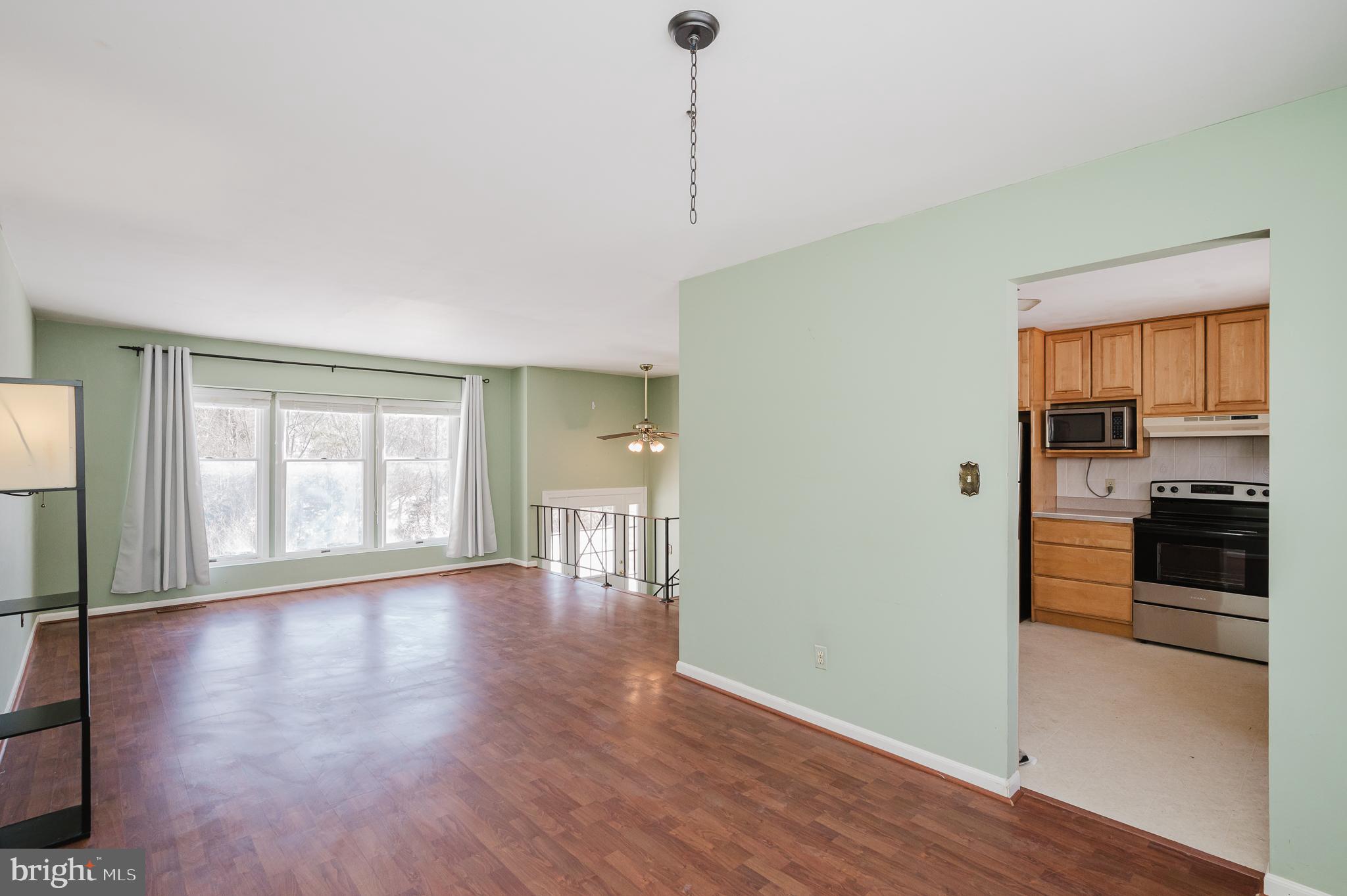 2804 Rocks Road Jarrettsville, MD 21084 - Photo 18 of 46 a view of a kitchen and an empty room with wooden floor and a window