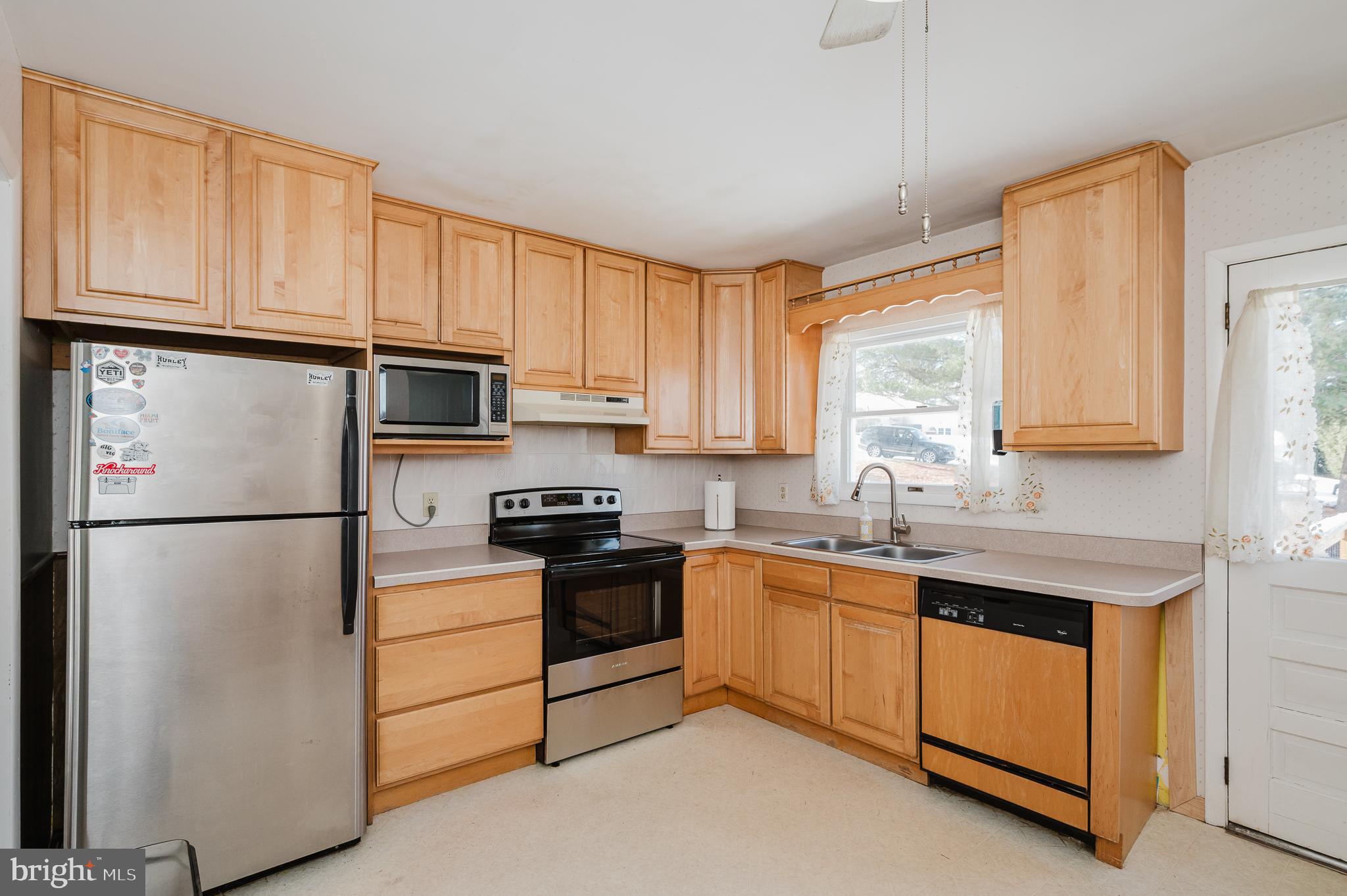 2804 Rocks Road Jarrettsville, MD 21084 - Photo 21 of 46 a kitchen with stainless steel appliances granite countertop a refrigerator sink stove microwave and cabinets