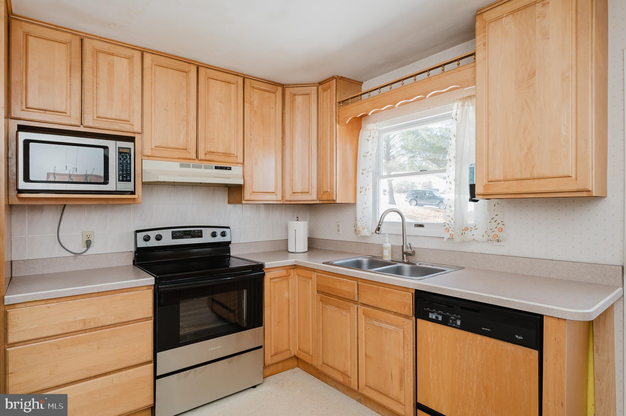 2804 Rocks Road Jarrettsville, MD 21084 - Photo 22 of 46 a kitchen with stainless steel appliances granite countertop white cabinets sink and window