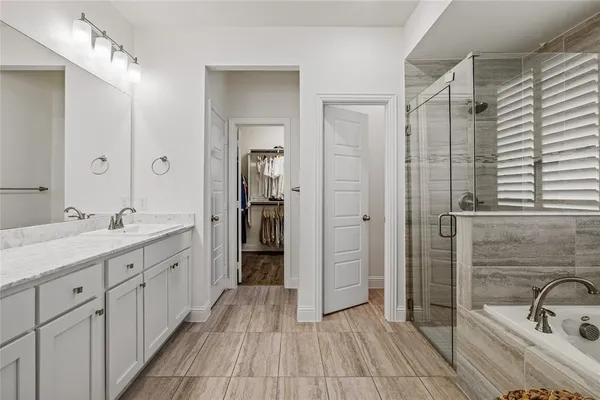 a bathroom with a double vanity sink and a mirror