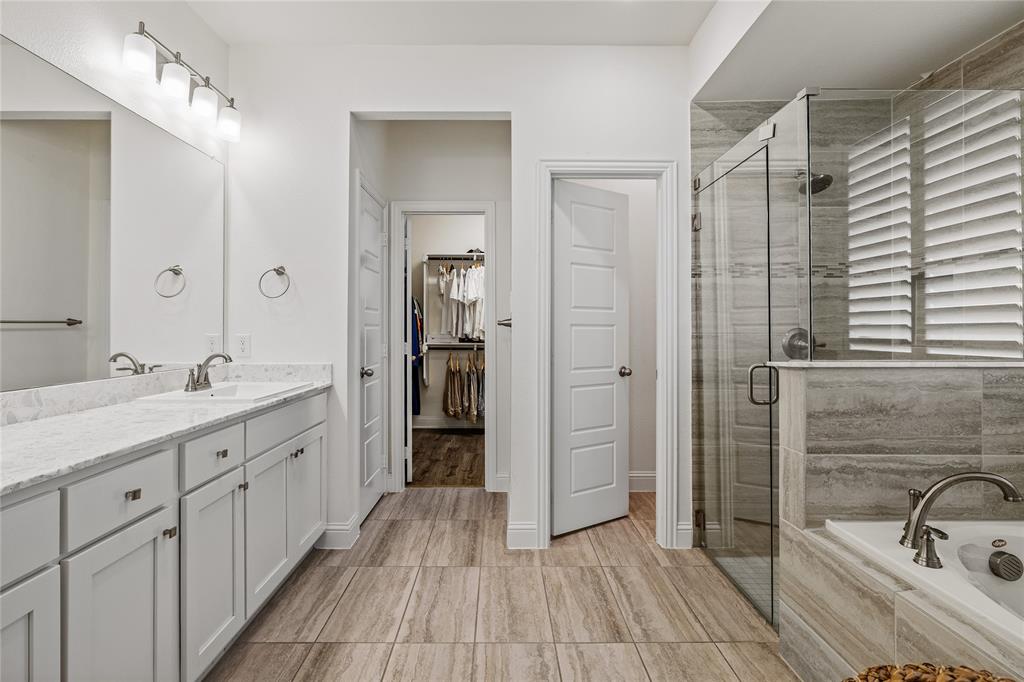 1430 Shaker Hills Road Gunter, TX 75058 - Photo 15 of 32 a bathroom with a double vanity sink and a mirror