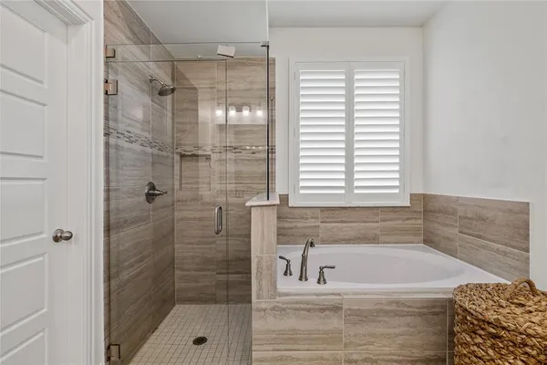 a bathroom with a shower and a bathtub