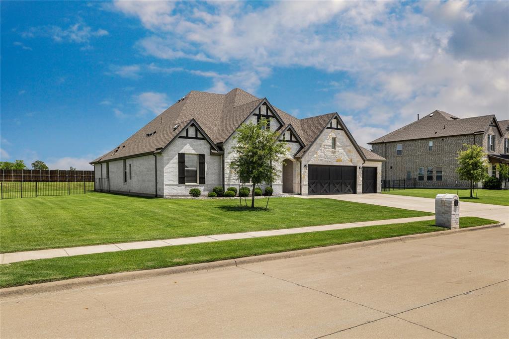 1430 Shaker Hills Road Gunter, TX 75058 - Photo 2 of 32 a front view of a house with a yard and garage