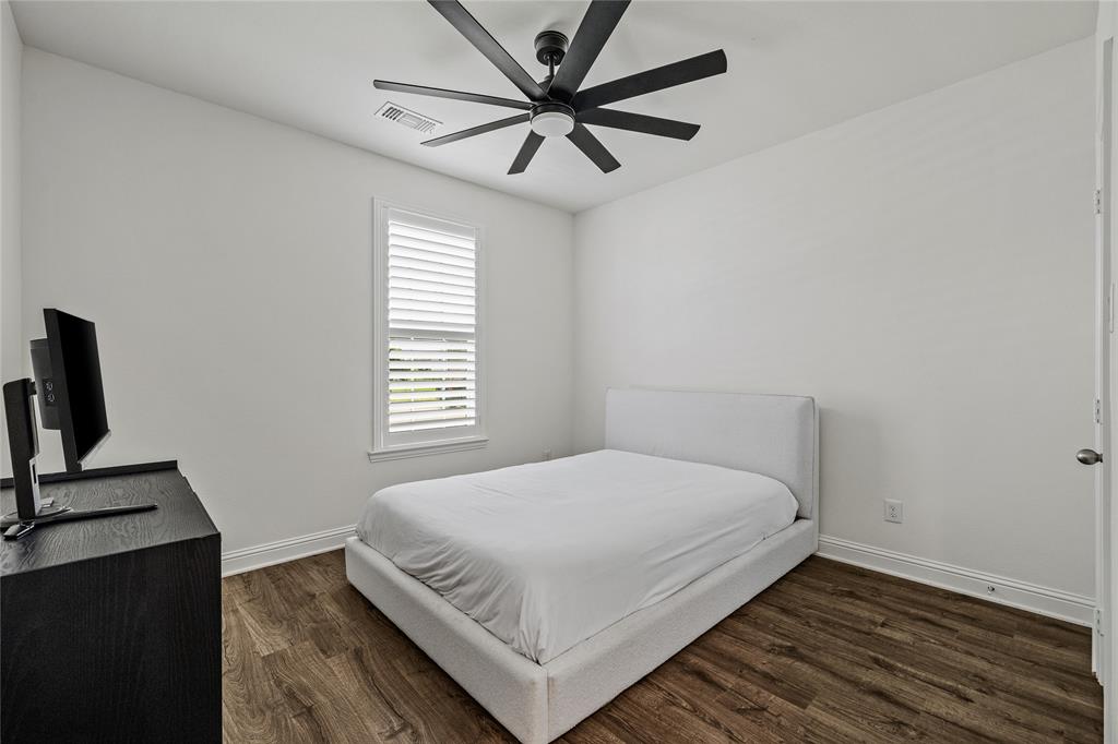 1430 Shaker Hills Road Gunter, TX 75058 - Photo 21 of 32 a large bed sitting in a bedroom next to a window