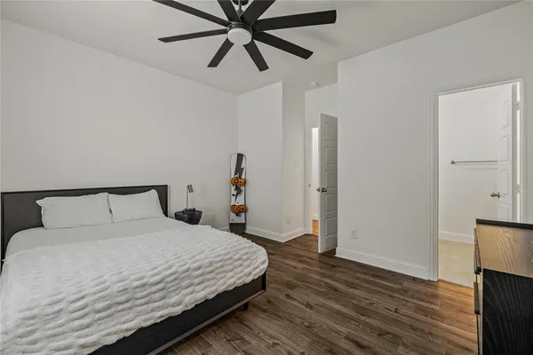 a bedroom with a bed and a ceiling fan