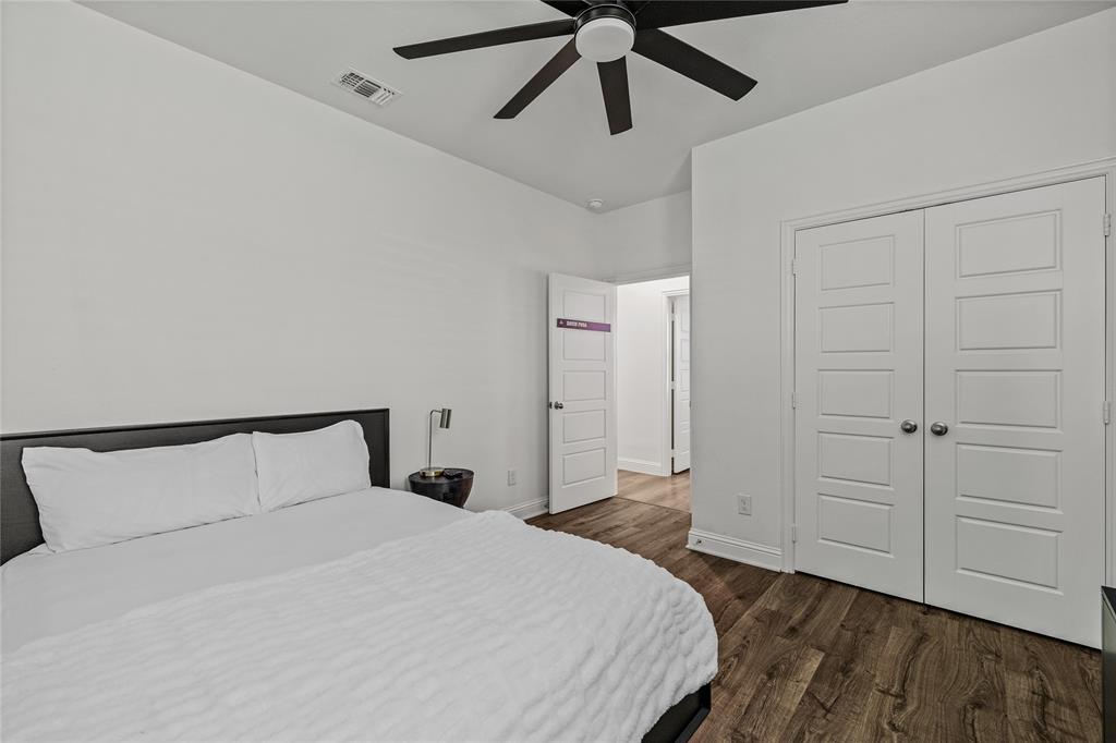 1430 Shaker Hills Road Gunter, TX 75058 - Photo 23 of 32 a bedroom with a bed and a ceiling fan