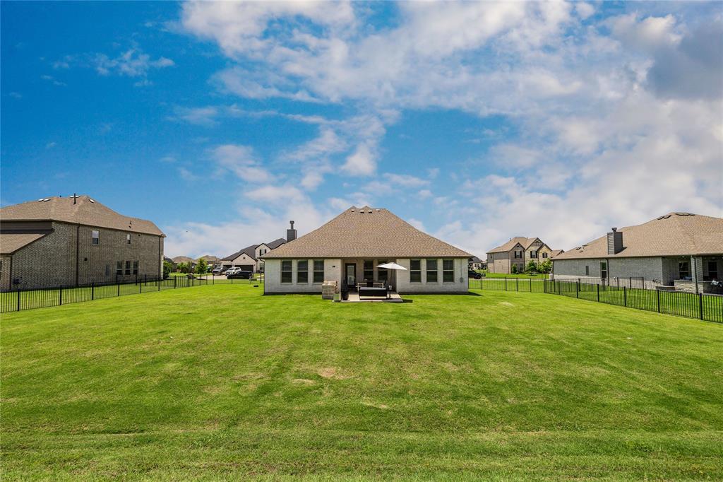1430 Shaker Hills Road Gunter, TX 75058 - Photo 28 of 32 a view of a big house with a big yard and large trees