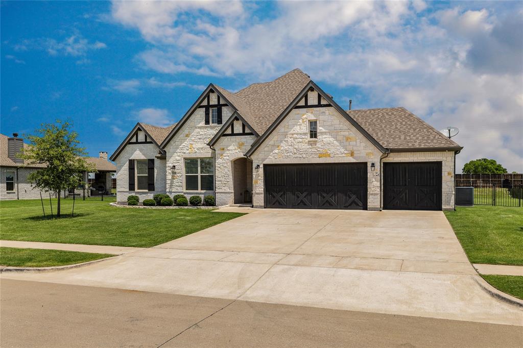 1430 Shaker Hills Road Gunter, TX 75058 - Photo 3 of 32 a front view of a house with a yard and garage
