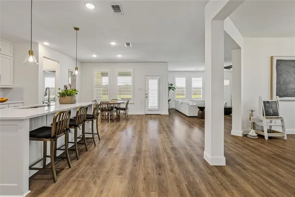a view of a dining room with furniture wooden floor and chandelier