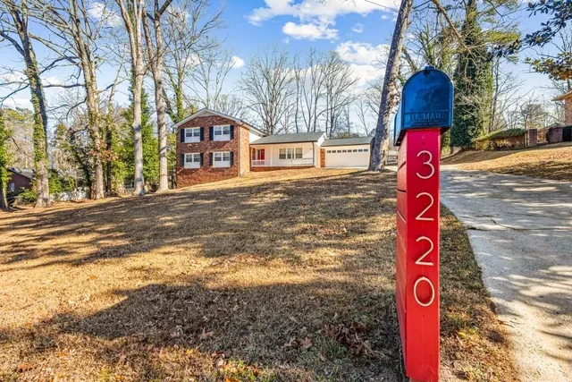 a street sign on a sidewalk next to a road