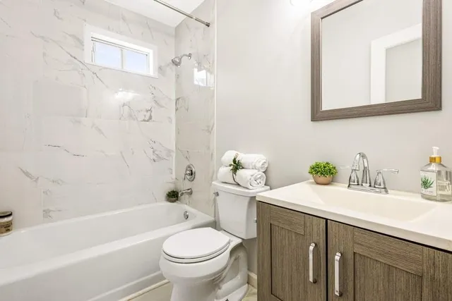 a bathroom with a sink a toilet and a bathtub