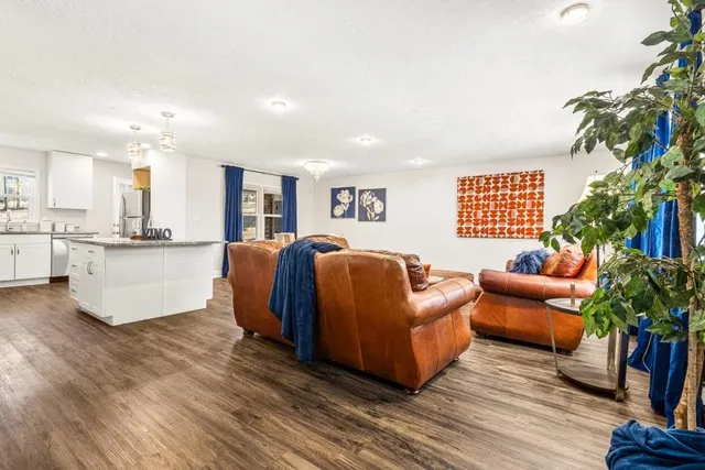 a living room with furniture and a potted plant