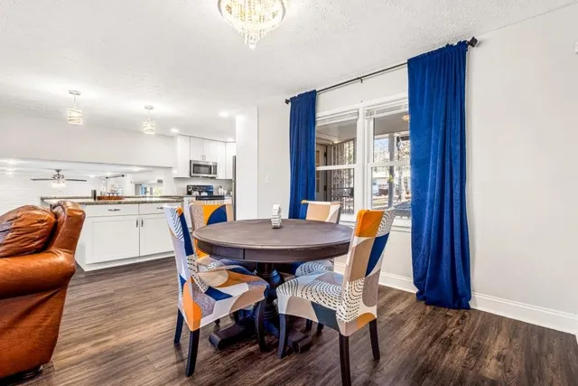 a view of a dining room with furniture and wooden floor