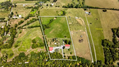 a view of a house with backyard and a park