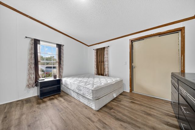 a view of a green field with trees in the background