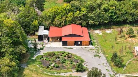 a kitchen with stainless steel appliances granite countertop a refrigerator a sink dishwasher a stove with wooden cabinets and floor