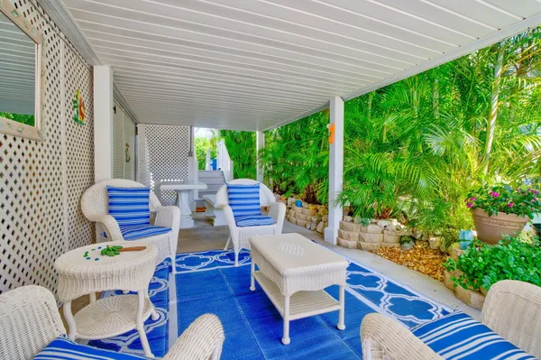 a view of a patio with couches chairs and potted plants
