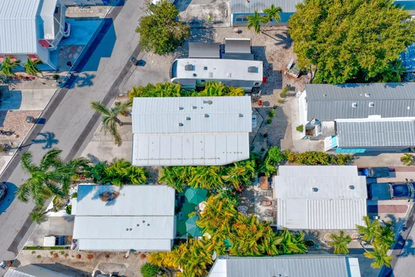 an aerial view of residential houses with outdoor space and lake view