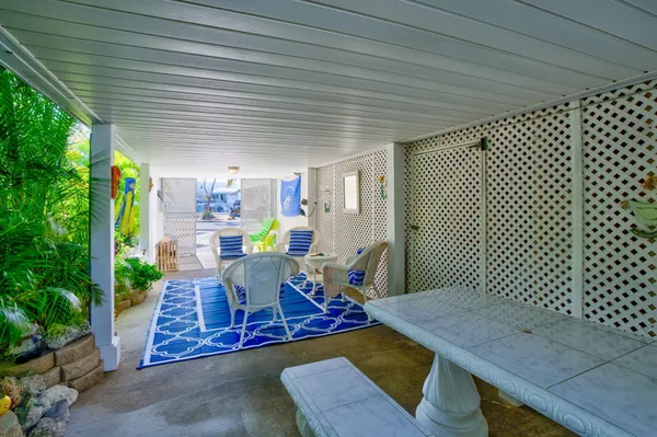 a view of a chairs and table in a patio
