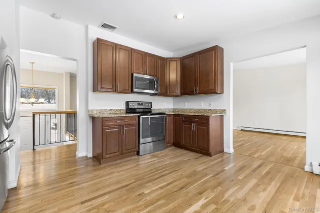 a kitchen with a sink cabinets and stainless steel appliances