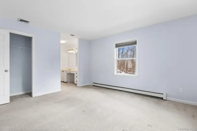 an empty room with windows and closet