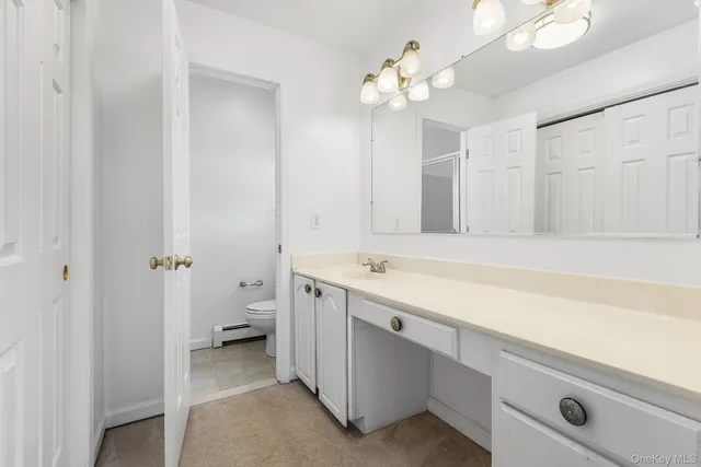a bathroom with a sink a light fixture and a mirror