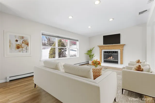 a living room with furniture and a fireplace