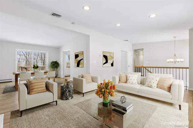 a living room with furniture potted plant and a window